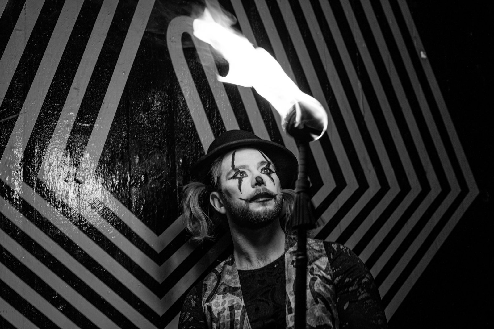 Chance Eaton, fire performance, in face paint with a lit torch